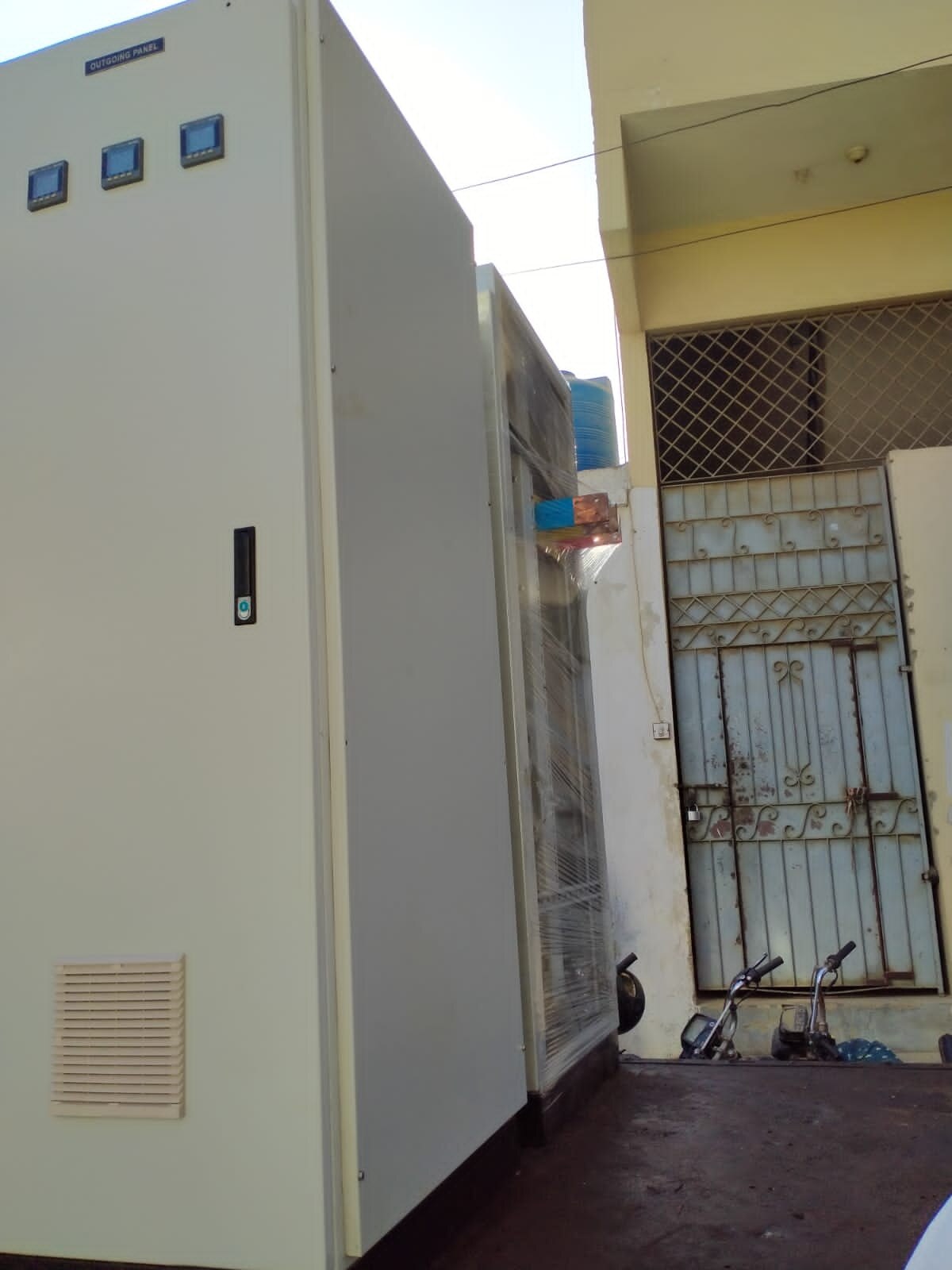 Electrical equipment and technicians at an outdoor site